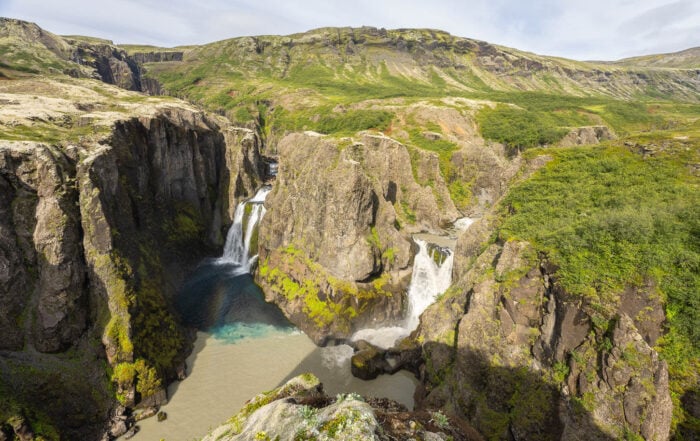 View of Hvitárfoss and Núpsárfoss, twin waterfalls with waters of different colors