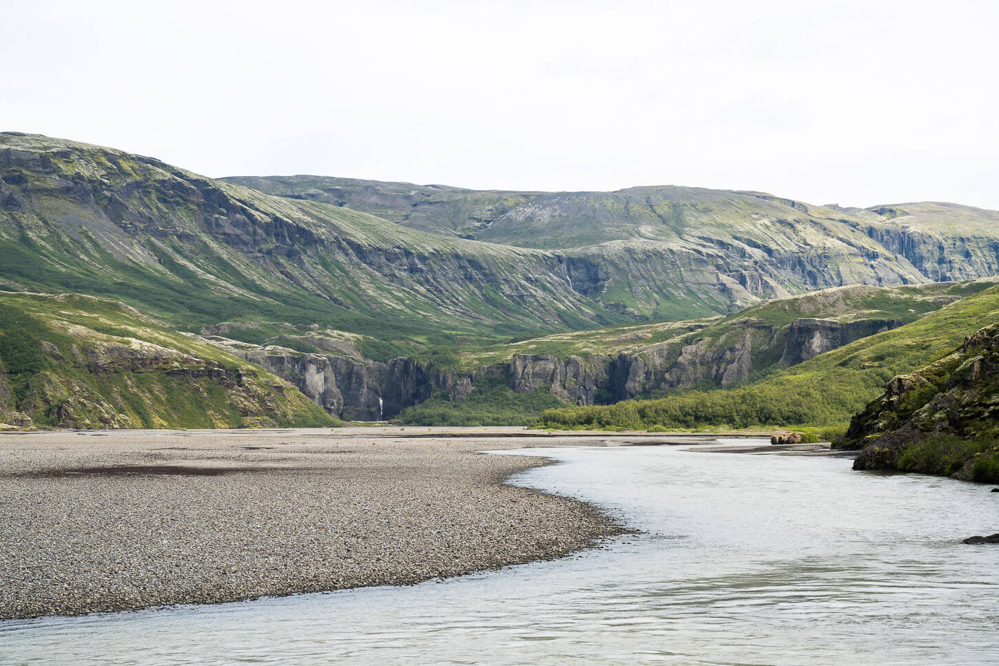 pristine landscape with a meandering river and mountains with canyons in iceland.