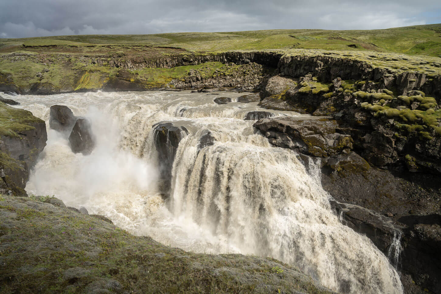 Lambhafgafoss, a waterfall surrounded by ancient moss-covered lava filelds along the Hverfisfljót river