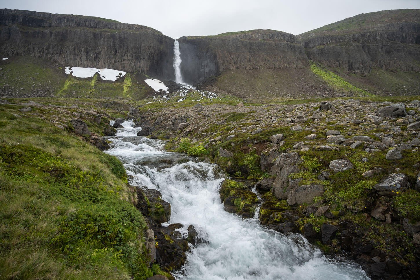 View of Mongufoss at the end of the hike, of a tall waterfall in the Westfjords that falls from high cliffs