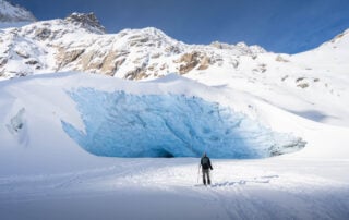 Sidelengletscher view with a hiker on snowshoes in front of the glacier