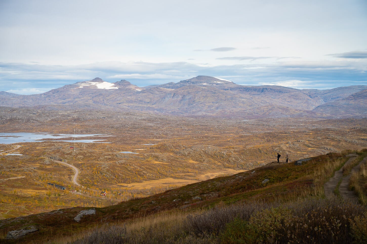 Hikers watching the vast landscape in Sweden