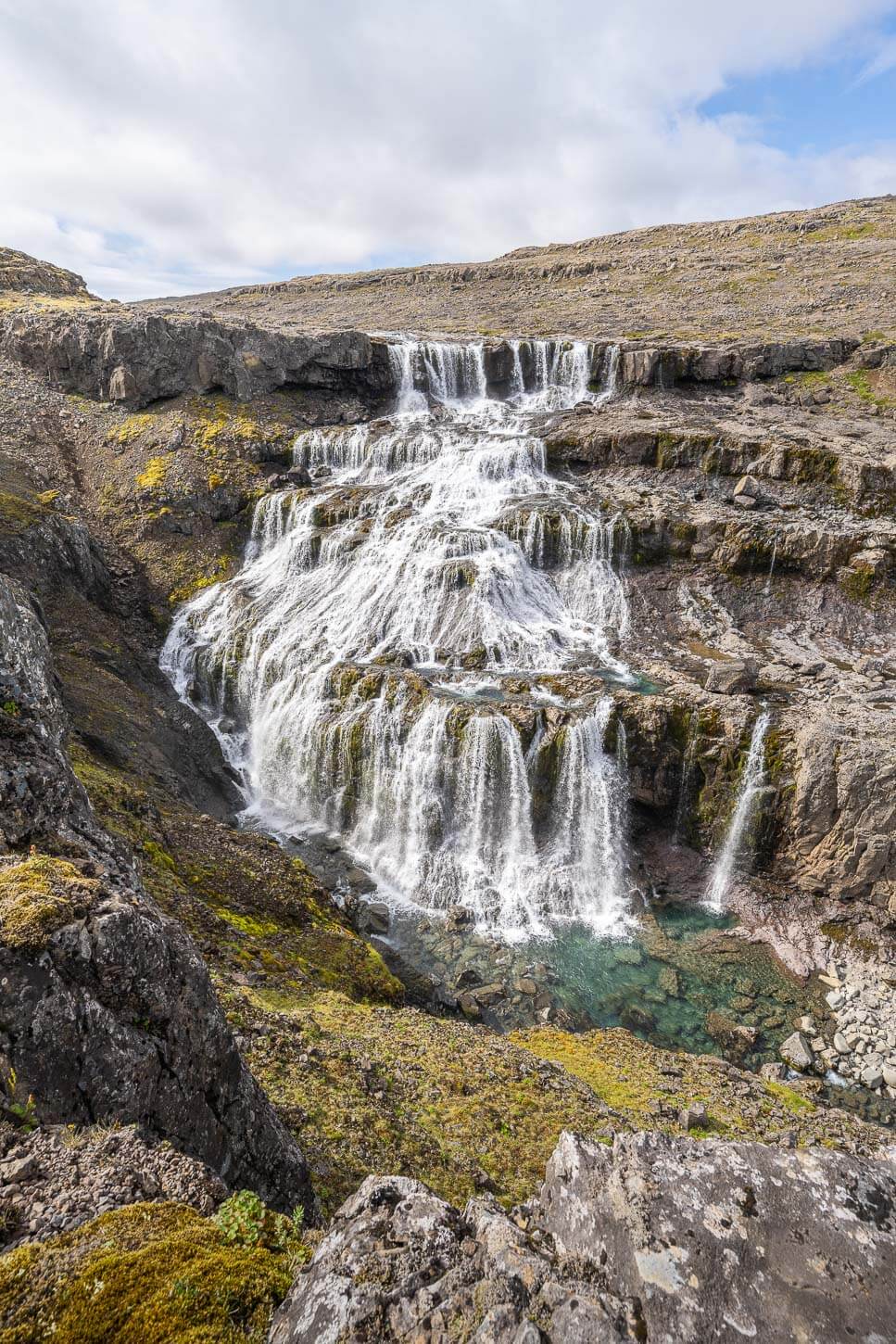 Rjúkandafoss is a tall, hidden waterfall deep in the Westfjords.
