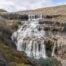 VIew of Rjúkandafoss a remote, multi-step waterfall in the Westfjords.