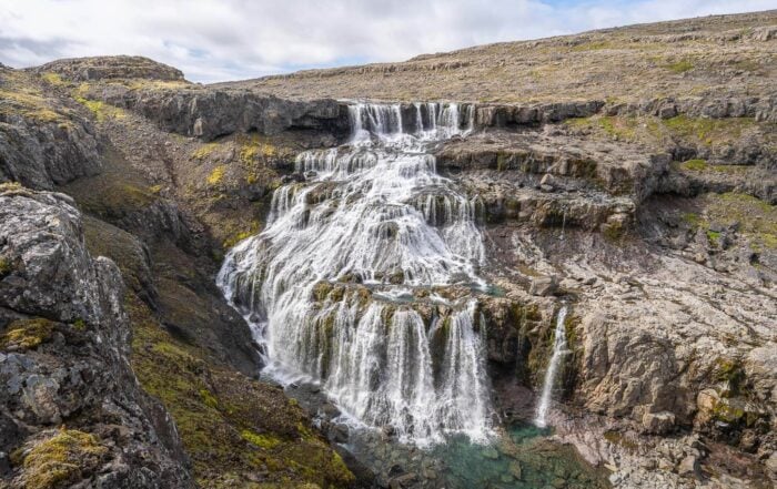 VIew of Rjúkandafoss a remote, multi-step waterfall in the Westfjords.