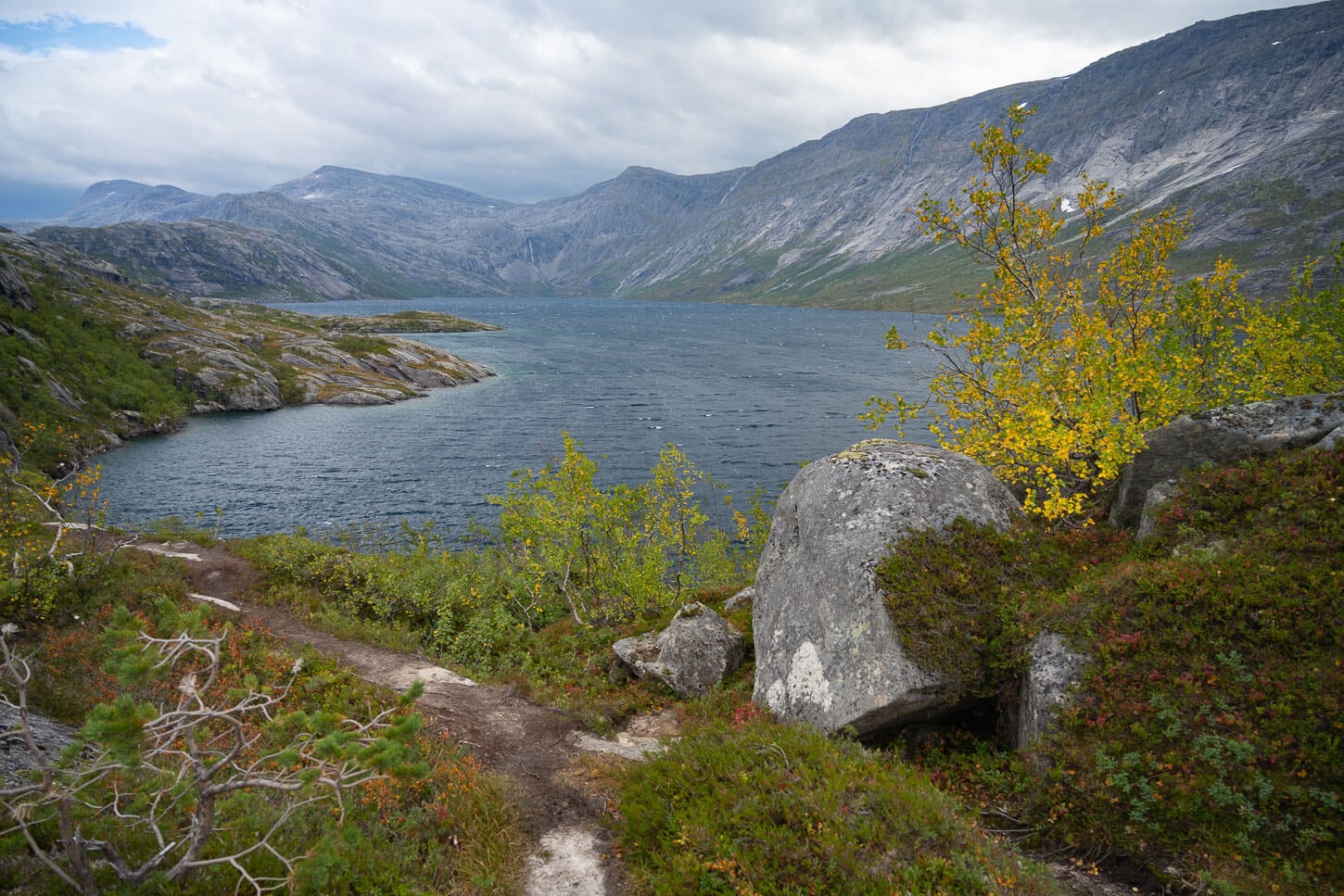 Litlverivatnet a blue-water lake in Northern Norway surrounded by dramatic cliffs.