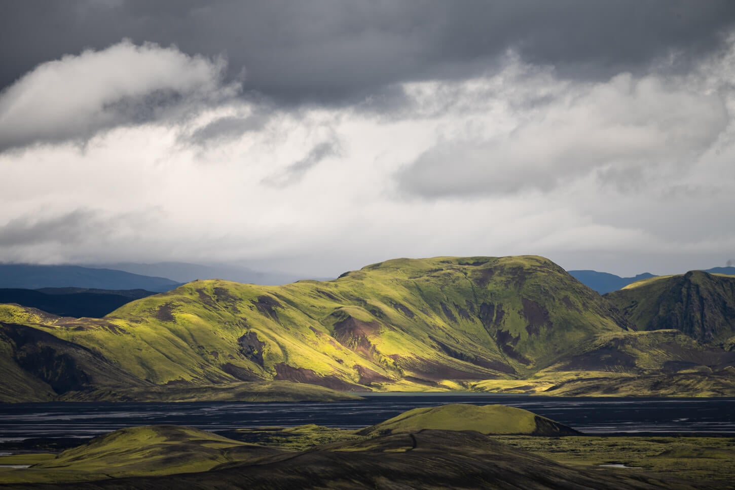 Lights and shadwos in a landscape photos of a hill in the highlands of Iceland taken with a 400mm lens.