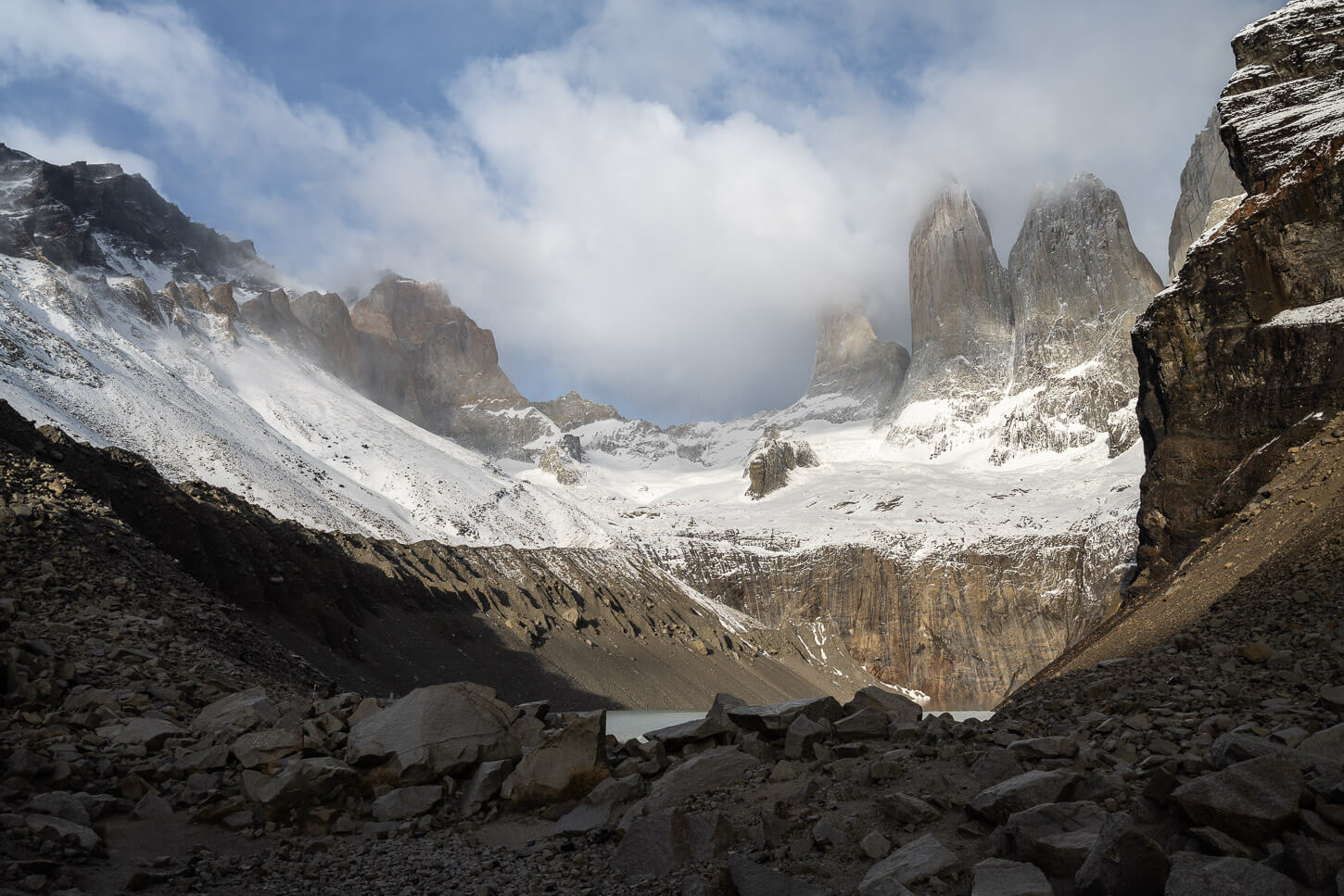 View of the Torres in Torres del Paine, partly covered in snow.
