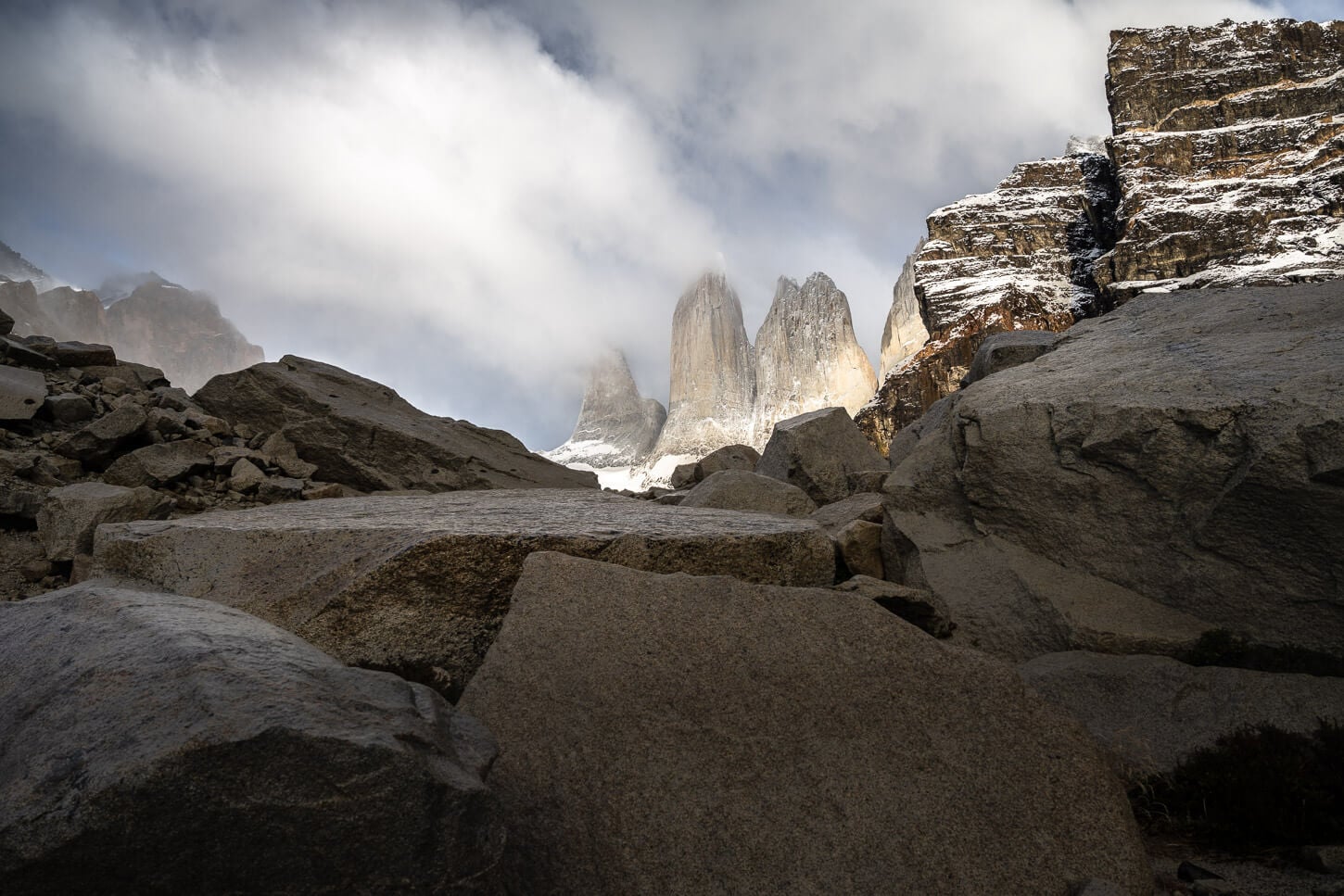 View of the Torres with light shining on them on a partly cloudy day