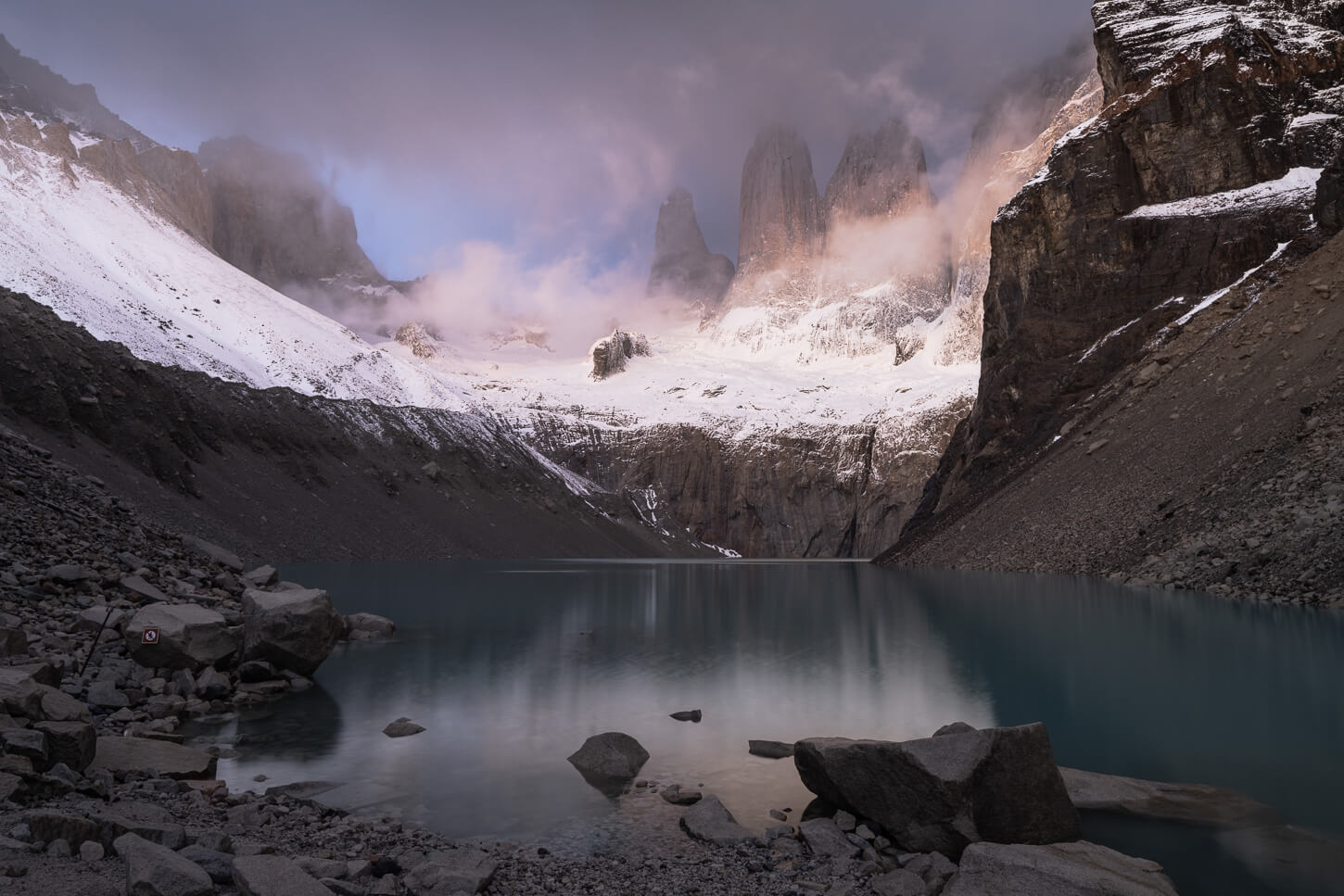 Dramatic landscape of Mirador Base Torres with the Torres partly covered in clouds.