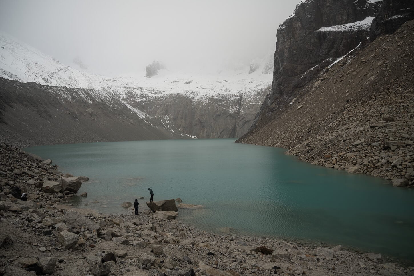 Mirador Base Torres covered in fog, with hikers patiently waiting for the sky to clear.