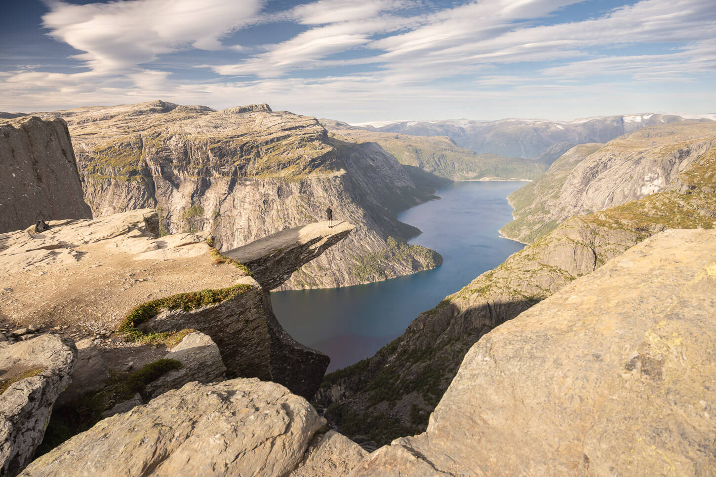 Photo of a hiker standing on Trolltunga