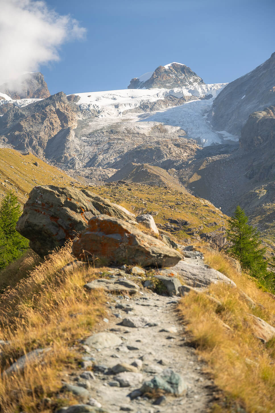 Ridge trail atop a Moraine with an imposing glacier in the distance.