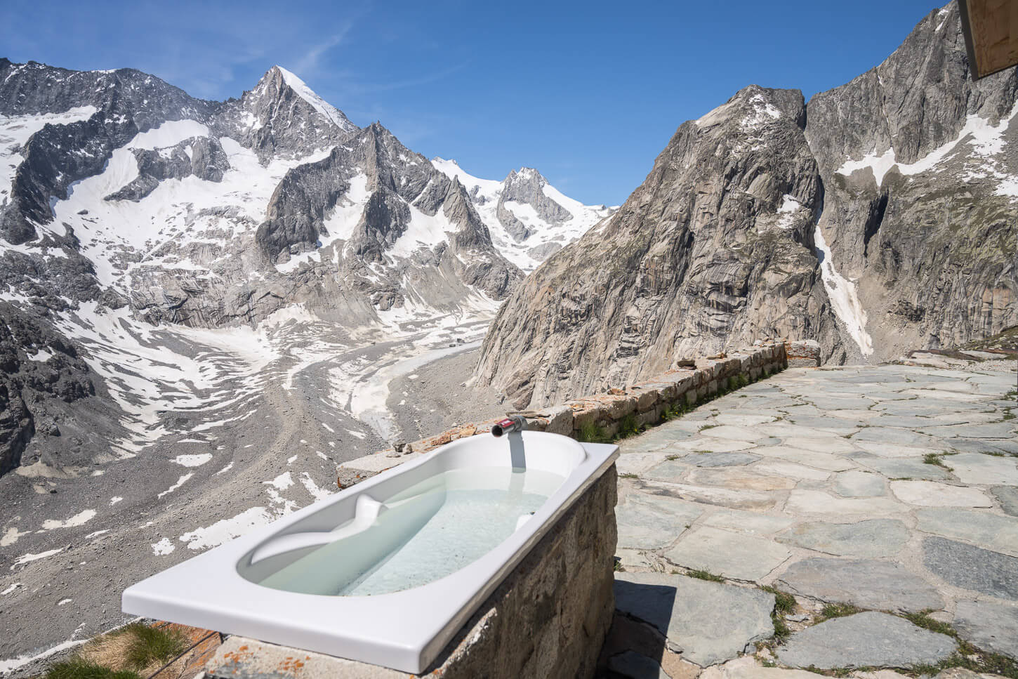 Bathtub by the Oberaletschhütte with the jaggged peaks of the alps around it
