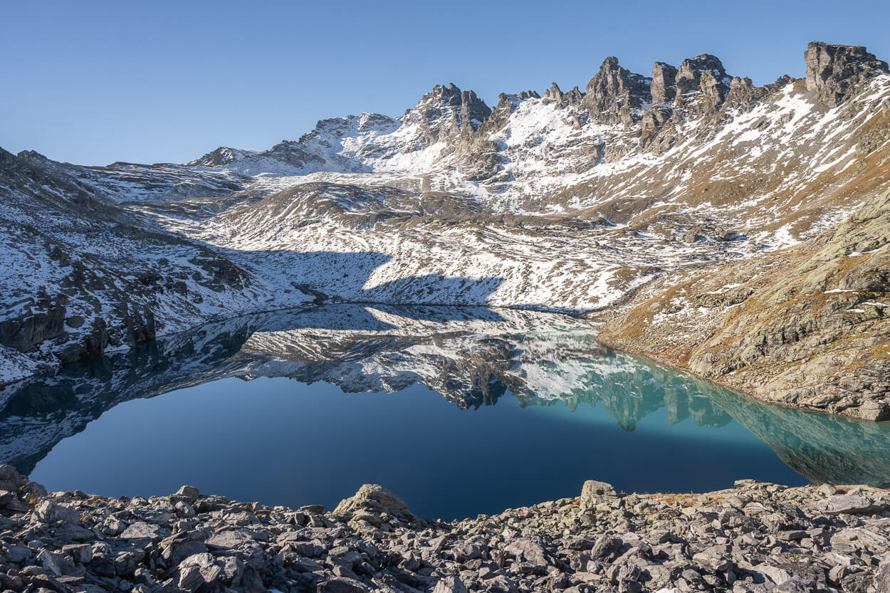 Sun partly shining on Wildsee on the Pizol five lakes hike in early autumn, in October.