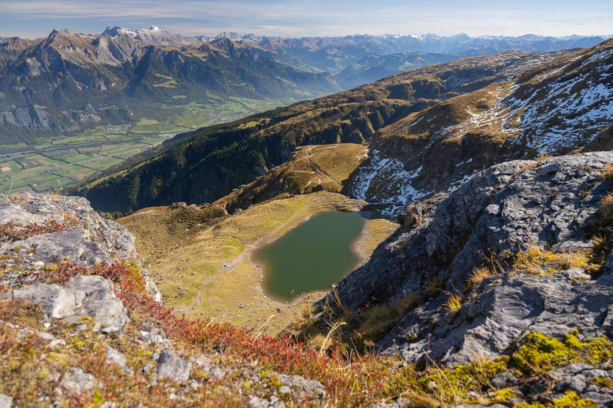 Baschalvasee, an alpine lakes viewed from above, with a seemingly endless mountain chain in the background