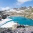 Hiker standing on a rock in front of Wildsee, the most popular lake on the Pizol Five Lakes Hike