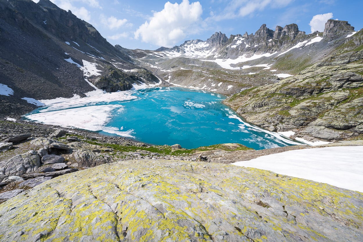 View of the turquoise waters of Wildsee, with jagged peaks in the background