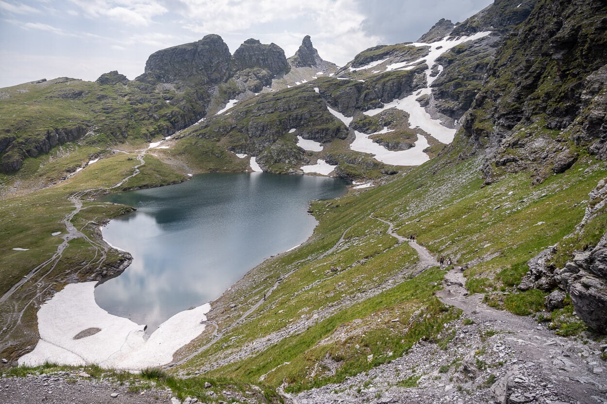 Schwarzsee in early summer, still partly covered in ice and snow.