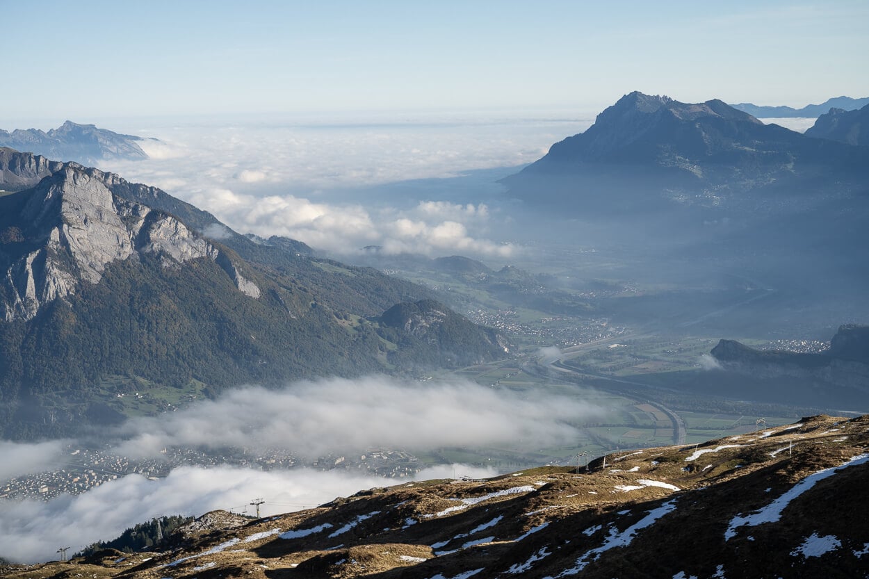 Panoramic View of the Rheintal valley from the Pizol five lakes trail, with low clouds hanging above it.