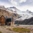 Puesto Cagliero, the end point of the Hike to the Outpost, with the view of the hut and the glacier in the background on a sunny day with vibrant autumn colors.