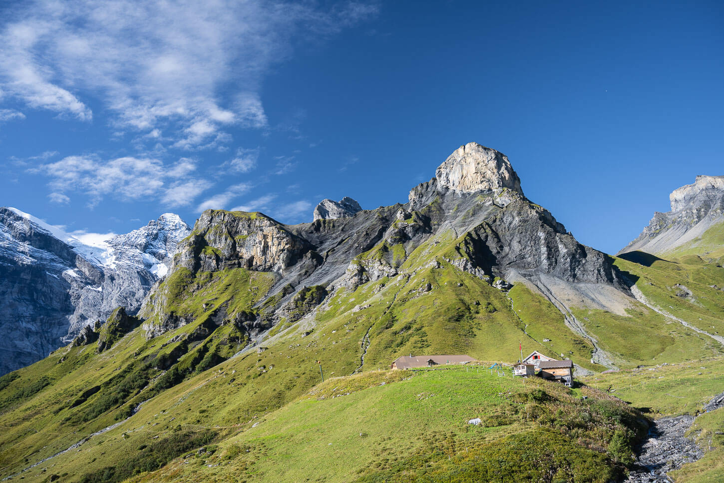 Rotstockhütte in the green landscape of the Bernese Oberland is an ideal stop on the hike to Schilthorn.