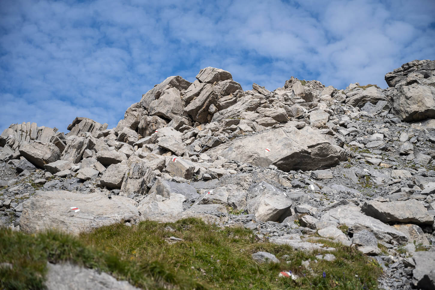 Boulder field on the trail to Schilthorn, with trail marks painted on the rocks at short distances.