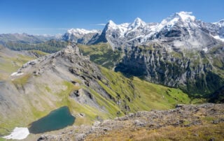 Epic Landscape photo from a Hike to Schiltorn with the green Lauterbrunnen Valley below the towering peaks of the Eiger, the Mönch, and the Jungfrau.