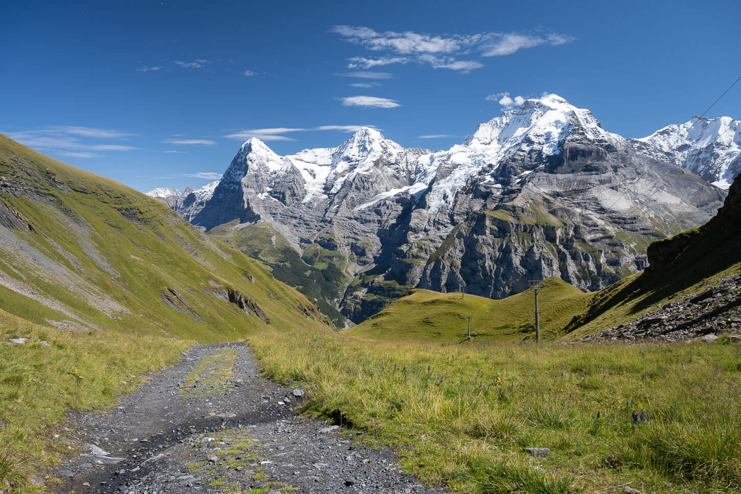 View of the Eiger, Monch and Jungfrau mountains from a gravel road on the opposite side of the valley.
