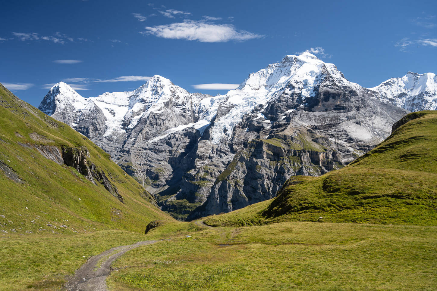 View of the snow-capped mountains of the Jungfrau region in Switzerland, from a road country that leads to Mürren