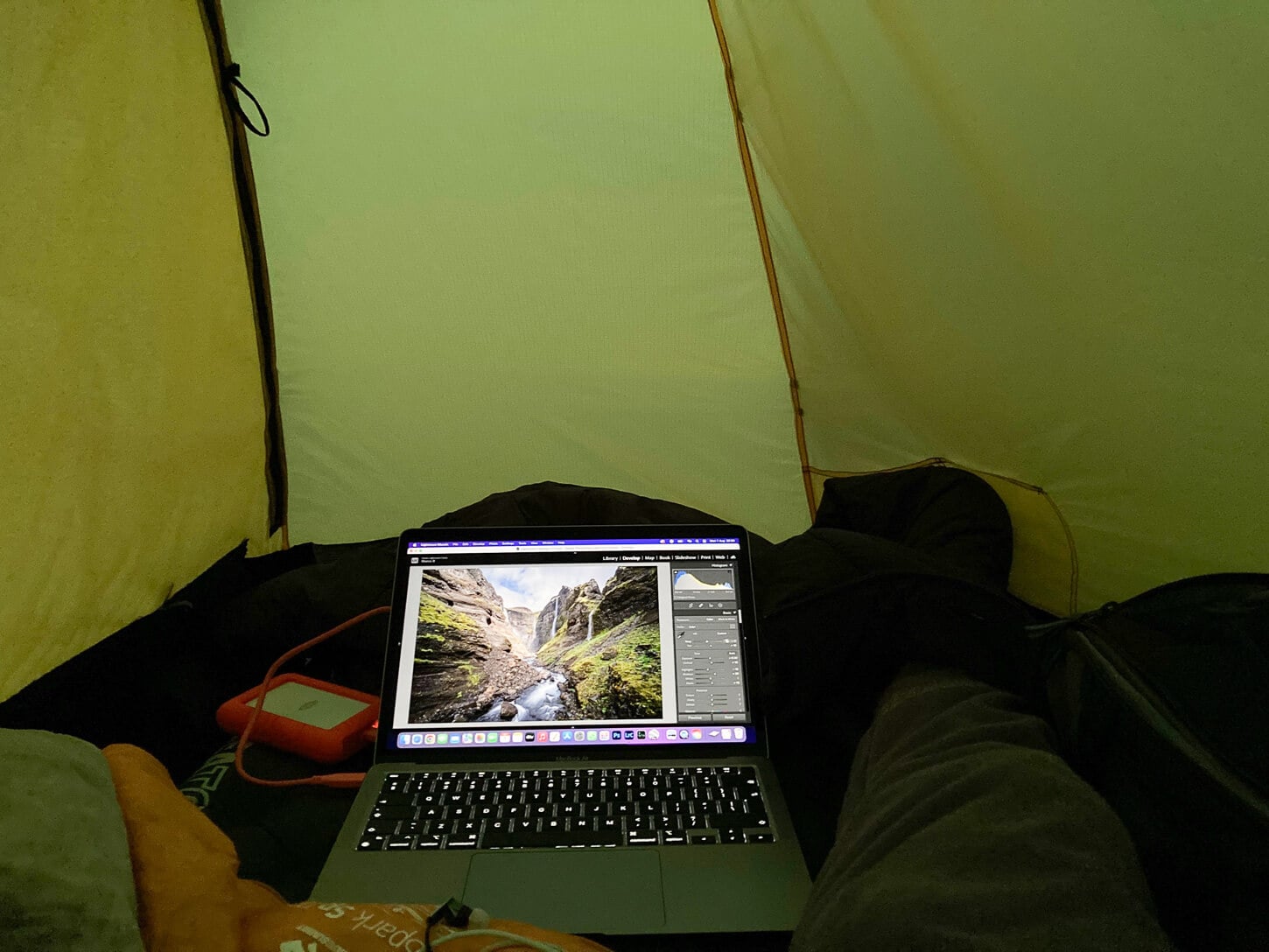 Inside a Hilleberg Soulo, with a laptop working on some photos.