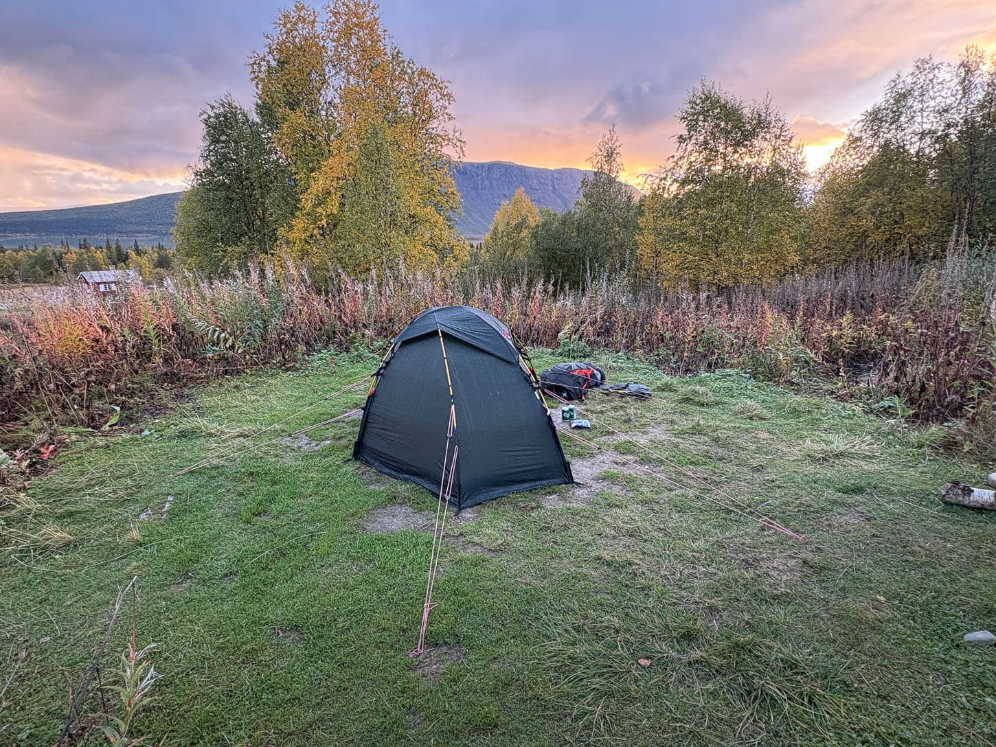 Hilleberg Soulo Tent pitched on a Grassy field in Swedish Lapland at sunset.