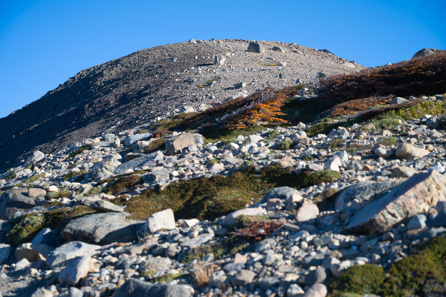 False Summit of Loma de Las Pizarras completely covered in rocks.