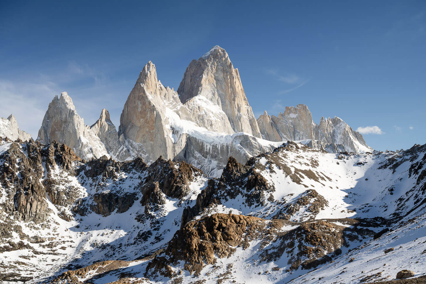 Mount Fitz Roy emerging from behind Loma de las Pizarras, with both moutains covered in snow