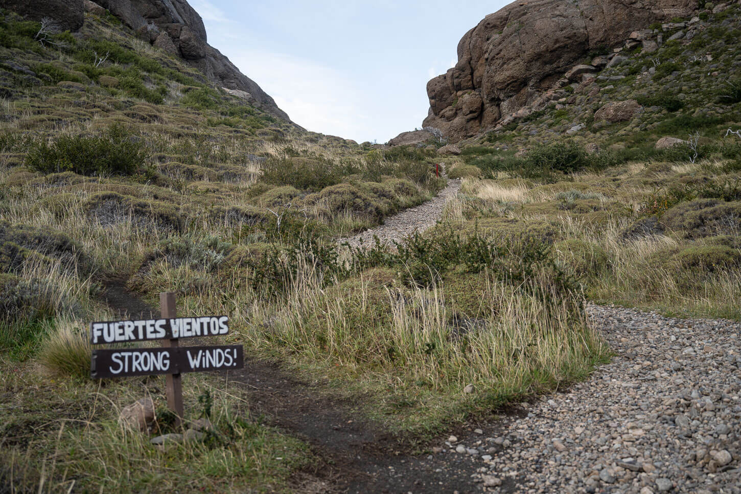 Strong Winds warning sign on the hiking trail on Patagonia, on a trail leading up to a small saddle.