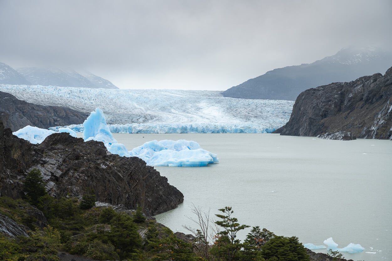 Panoramic view of Glacier Grey, with a gigantic iceberg floating in front of it.