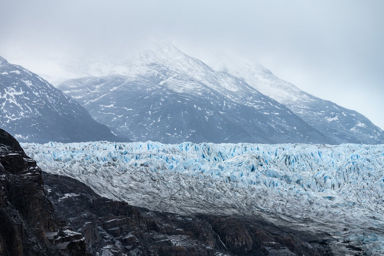Detail of Glacier Grey, seemingly suspended between the mountains behind and the rocky surface on which it lies.