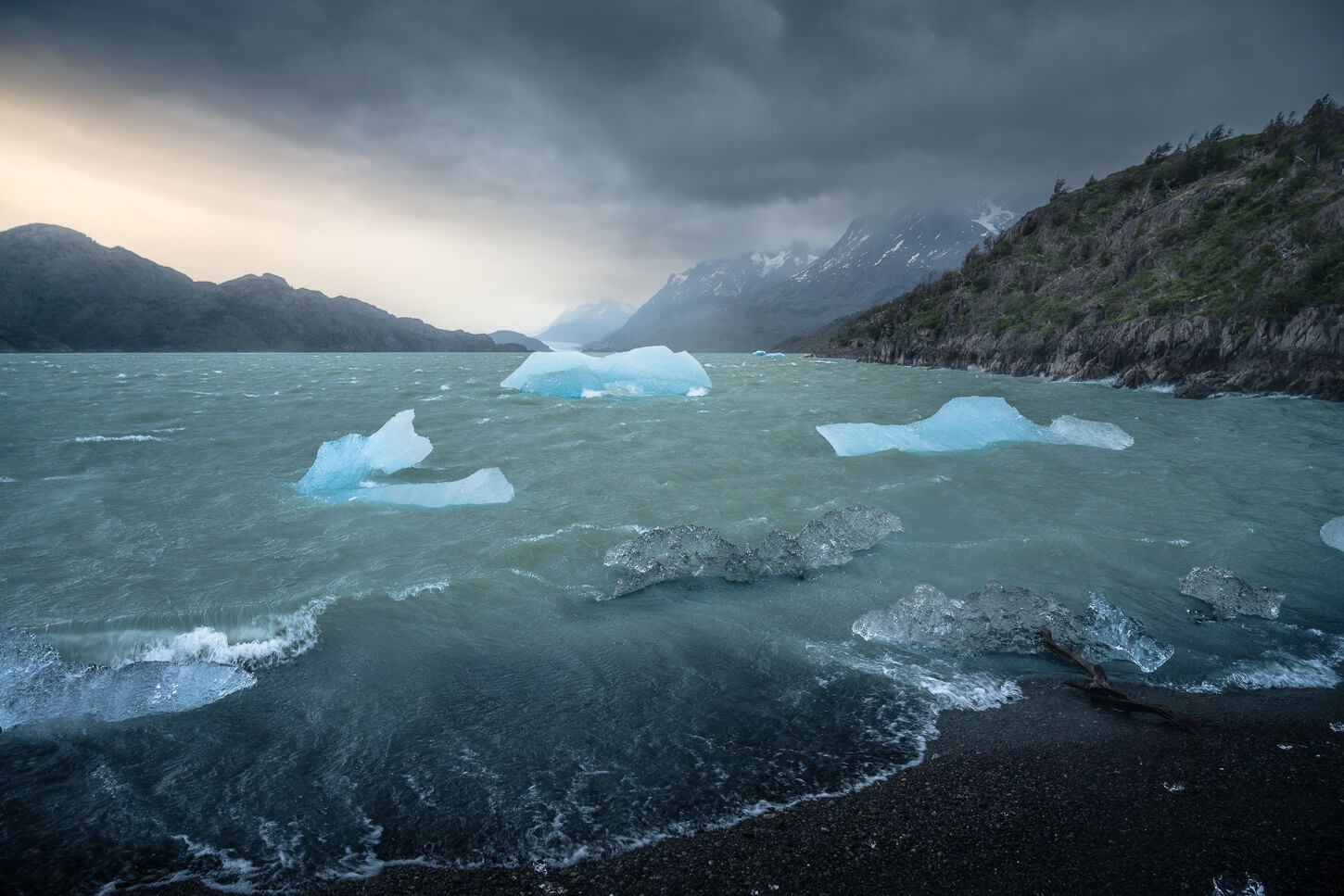 Icebergs in Lago Grey under a dramatic sky, photographed during a hike to Mirador de los Hielos