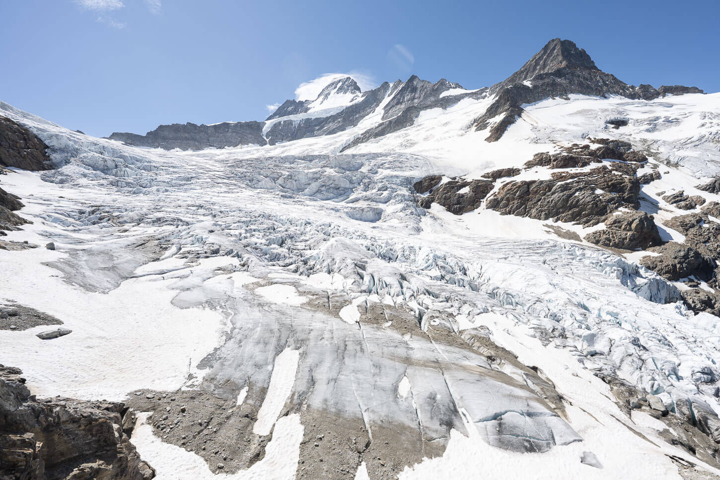 close view of the many crevasses of a glacier in the swiss alps.