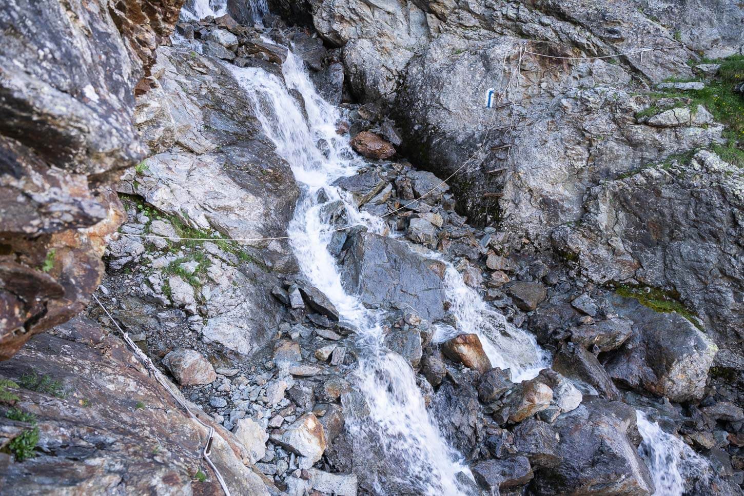 T4 section of the upper grindelwald glacier crossing a water stream with a ladder to climb on the opposite side.