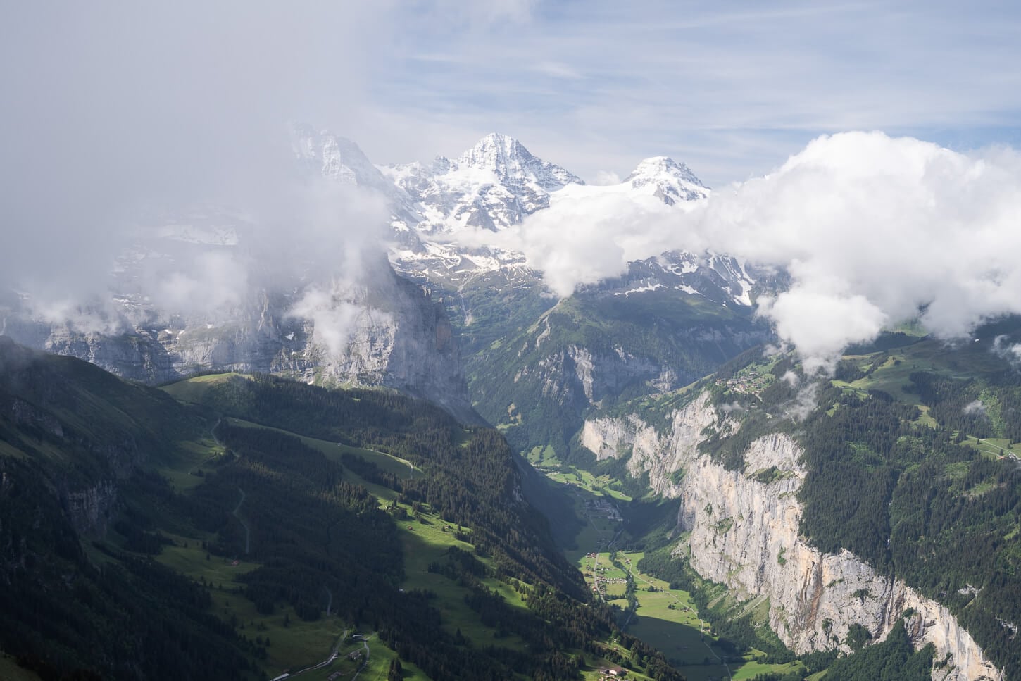 Panoramic view from Männlichen from the observation deck that is the endpoint of the hike too, with the lush green valley below.