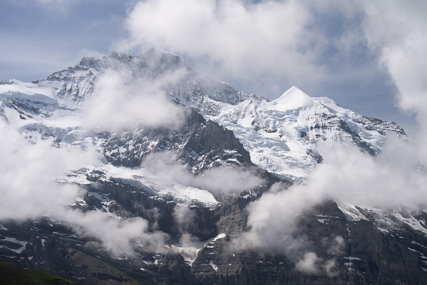 Mountain landscape of the Bernese Oberland with massive mountains covered in glaciers