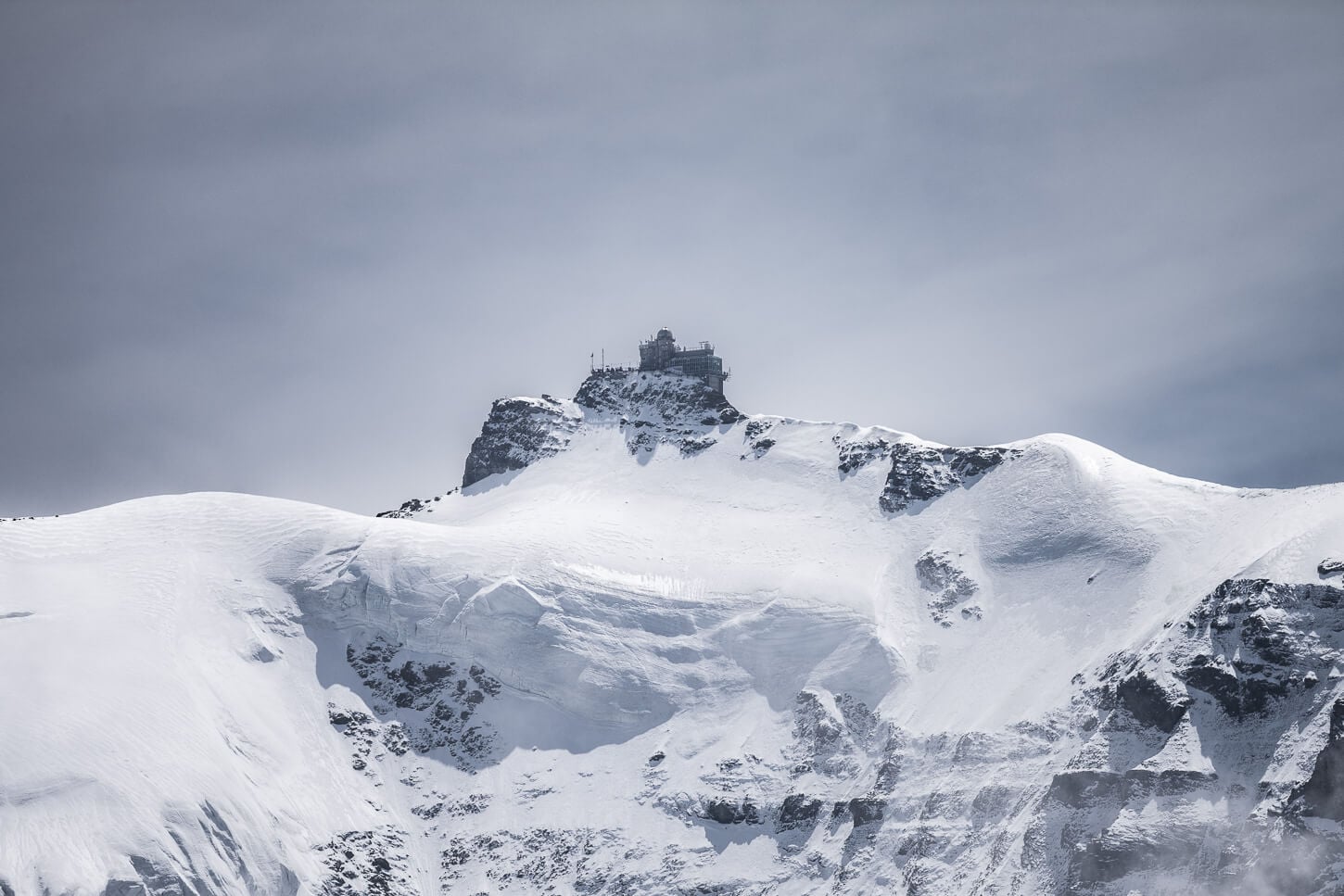 View of the Jungfraujoch station viewed from the hiking trail between Männlichen, Lauberhorn and Wengen.