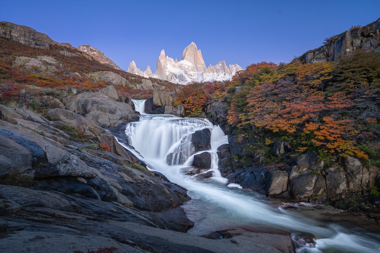Patagonia's Hidden Waterfall in El Chaltén, during the blue hour before sunrise, with mount Fitz Roy above it
