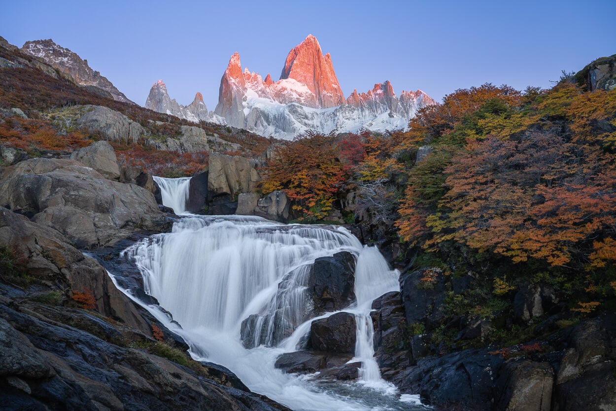 First light of the sun coloring mount Fitz Roy in an orange red glow.