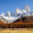 View of people on a Hike near El Chaltén, looking small compared to the towering Fitz Roy mountain above them.