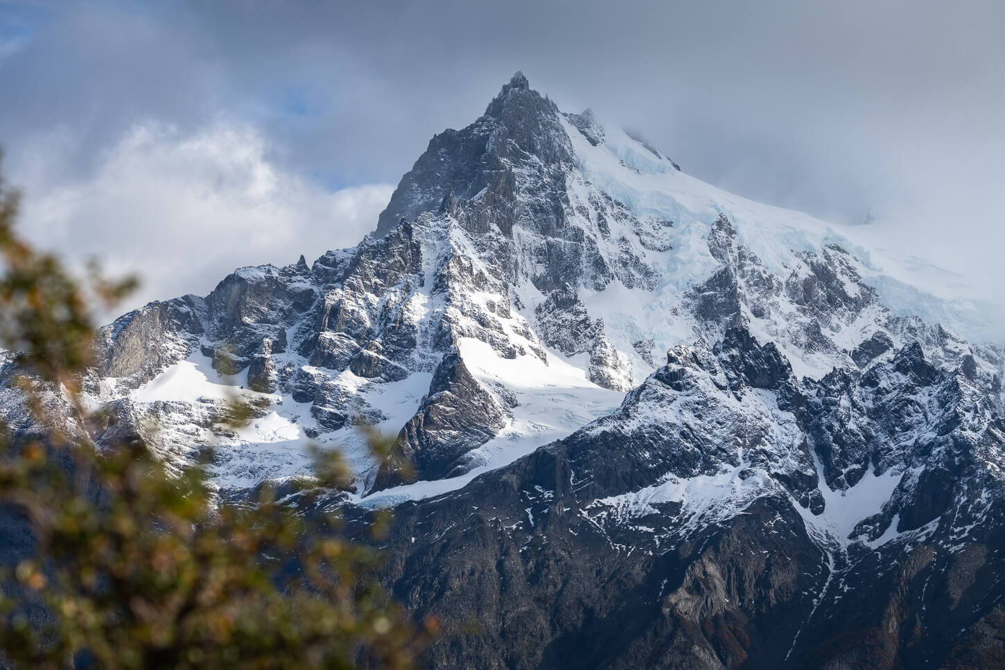 The Paine Grande mountain and its glaciers covered in snow and partly lit by the late afternoon sun