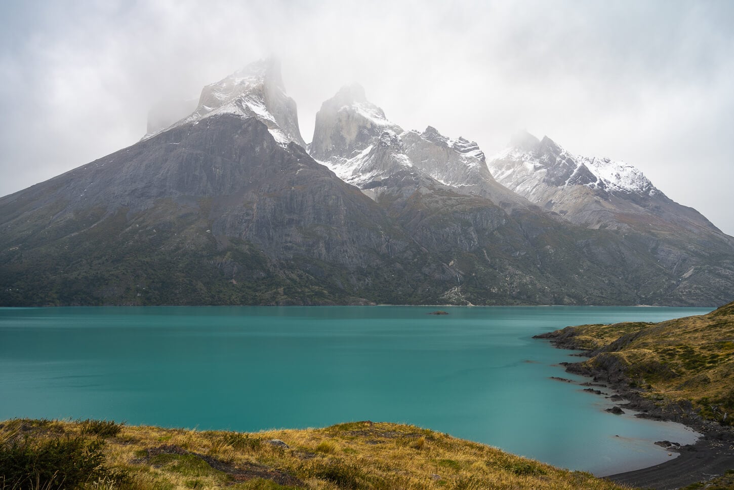 Clouse up view of the Cuernos group in the paine Grande Massif, un a cloudy and foggy day