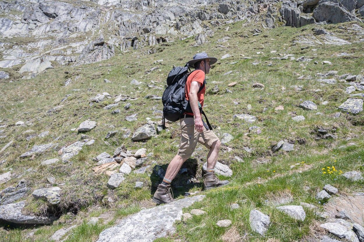 Hiker on a mountain with a black backpacl