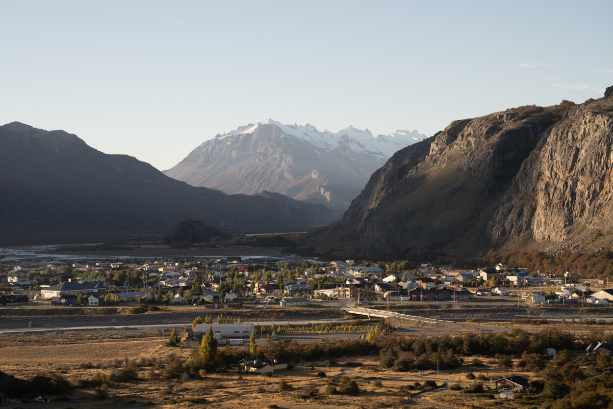 Golden Hour in Patagonia, with soft ligbht above a town nestled in a valley.